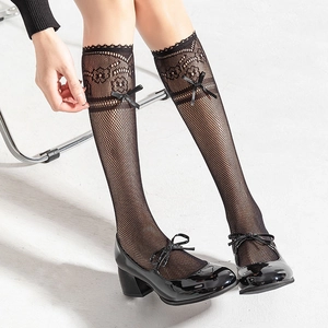 Lace ruffle mesh knee-high socks with silk bow detail paired with Mary Jane shoes