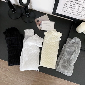 Detail of sheer sun-protection arm sleeves featuring vertical pleated texture in four colors