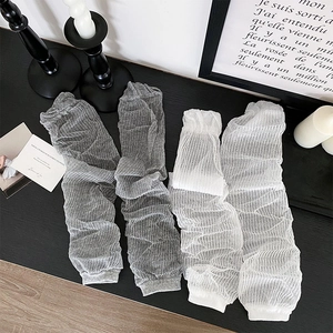 Detailed view of thin mesh knit arm warmers in grey and white with pleated texture