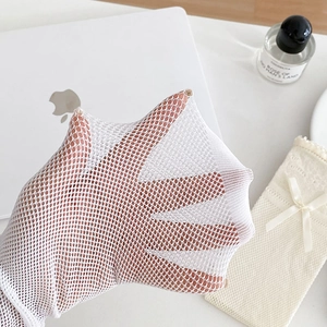 Close-up of white breathable mesh lace socks with intricate hollow-out texture for summer