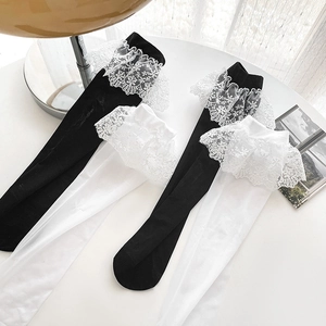 Lolita style knee high socks with delicate lace ruffles in black and white colors