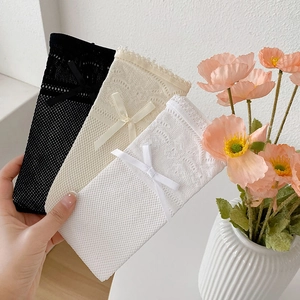 Detail of Lolita lace mesh socks in black beige and white with delicate bows
