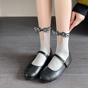 White crew socks with black Chinese frog button knots and Mary Jane shoes