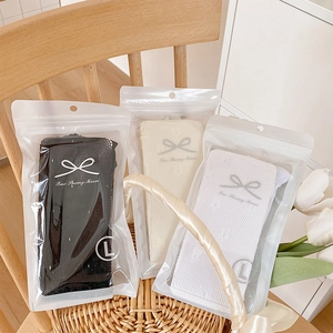 Three pairs of lace tights in black, beige, and white with floral mesh texture and L size tag