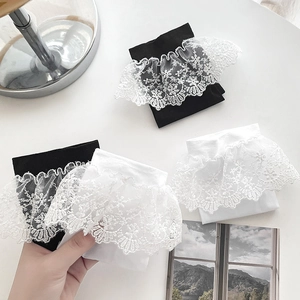 Detailed close-up of Lolita lace trim socks in black and white with floral patterns