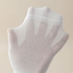 Close-up of white elastic mesh fabric showing breathable texture and honeycomb structure
