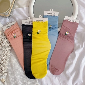 Five pairs of daisy embroidered mesh socks with ruffled edges in multiple pastel colors