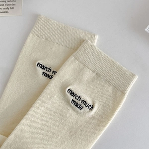 Detail of off-white cotton flip-flop socks with black march much made letter embroidery