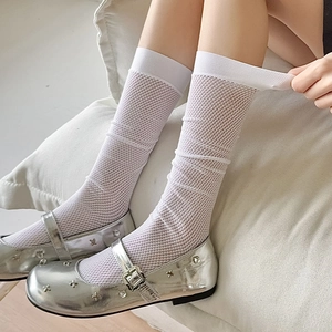 Detail of white mesh calf socks paired with silver metallic Mary Jane shoes and rhinestones