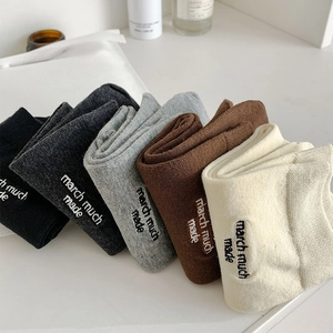 Detail view of five-color cotton split-toe socks with letter embroidery in soft knit fabric