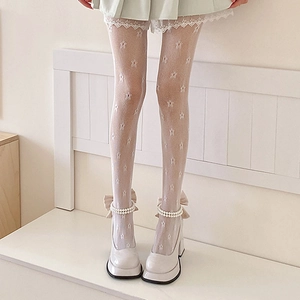 White star patterned lace tights with Lolita style pearl Mary Jane heels on a bench