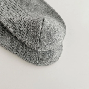 Close-up of gray ribbed knit texture on sweet ballet style socks for girls