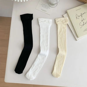 Three pairs of mesh knee-high socks in black, white, and beige with breathable texture