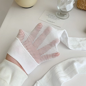 Detailed macro view of white breathable mesh fabric texture on high-stretch calf socks