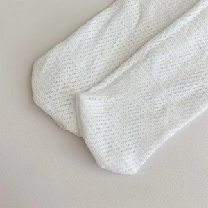 Detail of white mesh knit fabric with delicate diamond patterns for summer socks