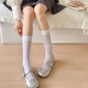 Detail of silver Mary Jane shoes with star rivets and white diamond mesh knee high socks