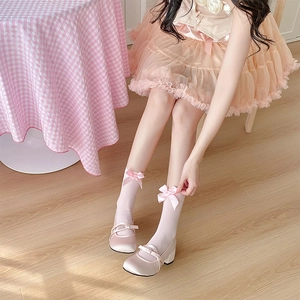 Detail of pink satin Mary Jane shoes with matching sheer bow-knot socks in Lolita style