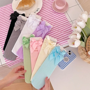 Close-up of pastel velvet bow socks in multiple colors with elegant ribbon details