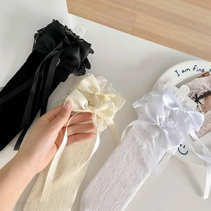Detailed lace knee-high socks with delicate silk bows in black, beige, and white colors