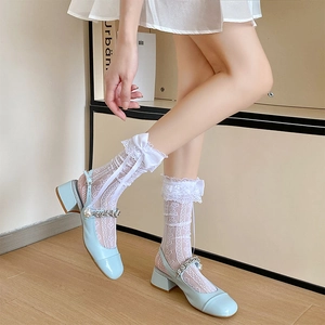 Blue patent leather Mary Jane shoes with pearls, rhinestones, and white lace bow socks