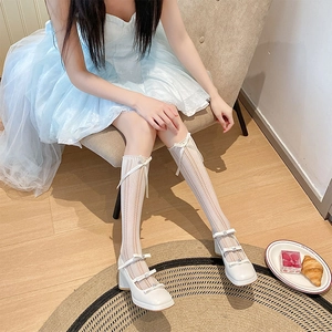 Detailed view of white Lolita socks with bow accents and rhinestone Mary Jane shoes