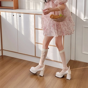 White Lolita lace calf socks featuring ribbon cross straps and cute bow accents
