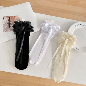 Detail of hollow lace calf socks with satin ribbons in black, white, and beige colors