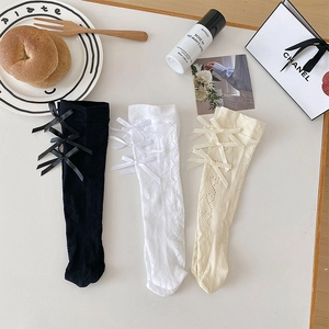 Japanese Lolita style knee high socks with ribbon bows and lace hollow mesh patterns