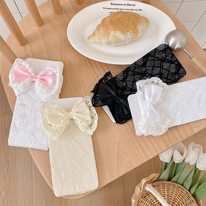Detailed lace texture and satin bow accents on assorted mesh knee-high socks