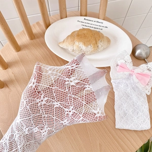 Detailed close-up of white mesh lace baby long socks with cute pink bow and high elasticity