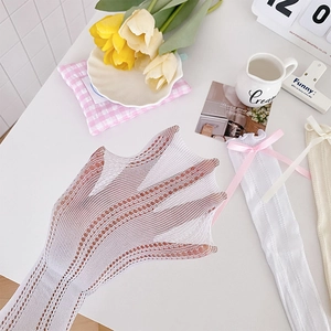Detailed view of white hollow mesh socks with elastic lace and pink ribbon bows