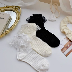 Three pairs of lace trim crew socks in white, cream, and black with vertical rib texture
