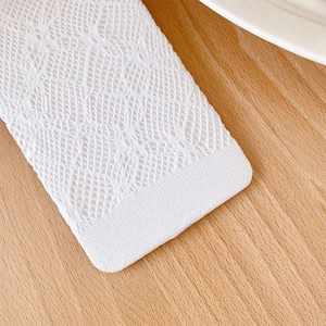 Close-up of white lace bow socks featuring intricate hollow mesh and scalloped edges