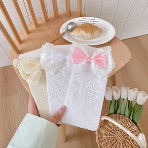 Detail of lace mesh bow socks featuring hollow weave patterns and delicate silk ribbons