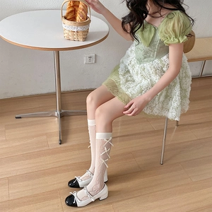 Detailed lace texture and bow accents on Lolita style calf socks in creamy white