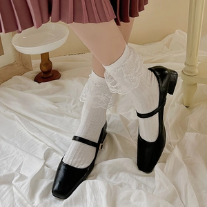 Lolita style white lace trim socks paired with black Mary Jane shoes and pleated skirt