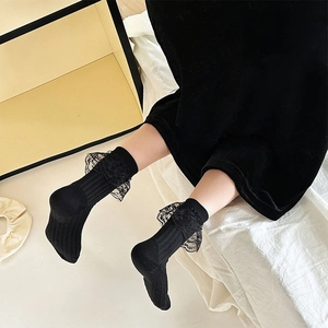 Detail of black lace trim on baby vertical stripe knit socks for sweet doll-like style