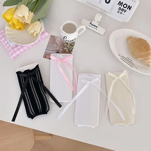 Detail view of lace-up hollow knit stockings with cute ribbon bows in various colors