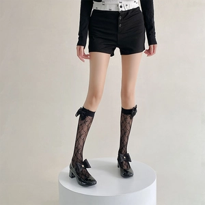 Detail of black lace hollow mesh socks with ribbon bow on a Mary Jane platform shoe