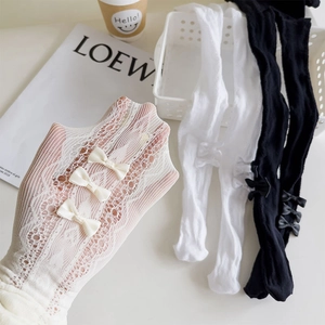 Detailed close-up of side bow accents and floral lace mesh texture on these pantyhose