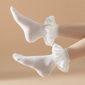 Detail showing white cotton socks with elegant double-layer satin ruffle lace trim