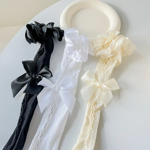 Close-up of Lolita lace socks with bow ties and hollow mesh texture in various colors