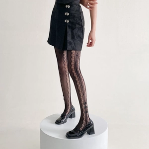 Detail of black lace tights featuring sweet bow patterns and vertical mesh side cutouts