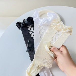 Detail of Lolita mesh socks featuring satin bow knots and ruffled lace trim accents
