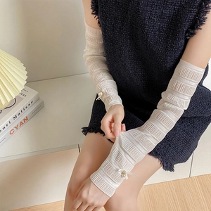 Elegant white mesh arm sleeves with pearl and bow accents for a balletcore style