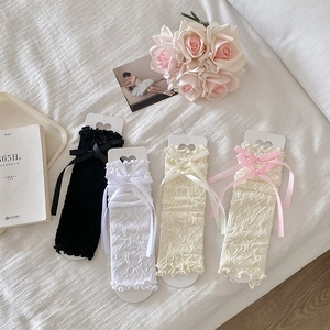 Detailed view of lace mesh leg warmers with bow accents in four elegant colors