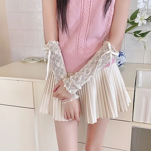 Detailed lace arm sleeves in cream white featuring elegant bows and ruffled edges