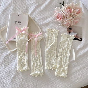 Detailed lace arm sleeves with cute ribbon bows and delicate ruffled edges in cream white
