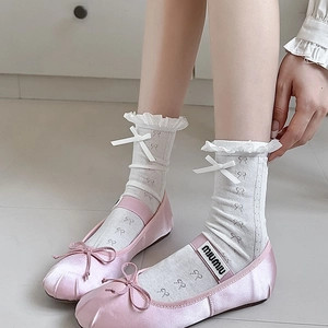 Pink satin ballet flats with logo straps and white lace bow knee-high socks