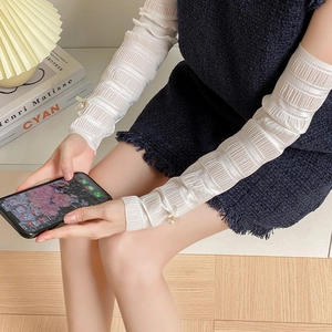 Detail showing white pleated leg warmers with delicate pearl bowknot embellishments